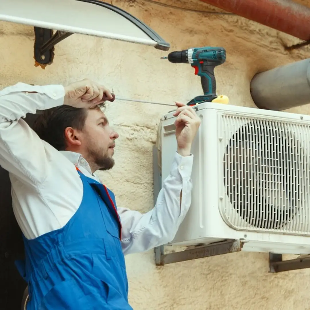 A man is fixing the air conditioner