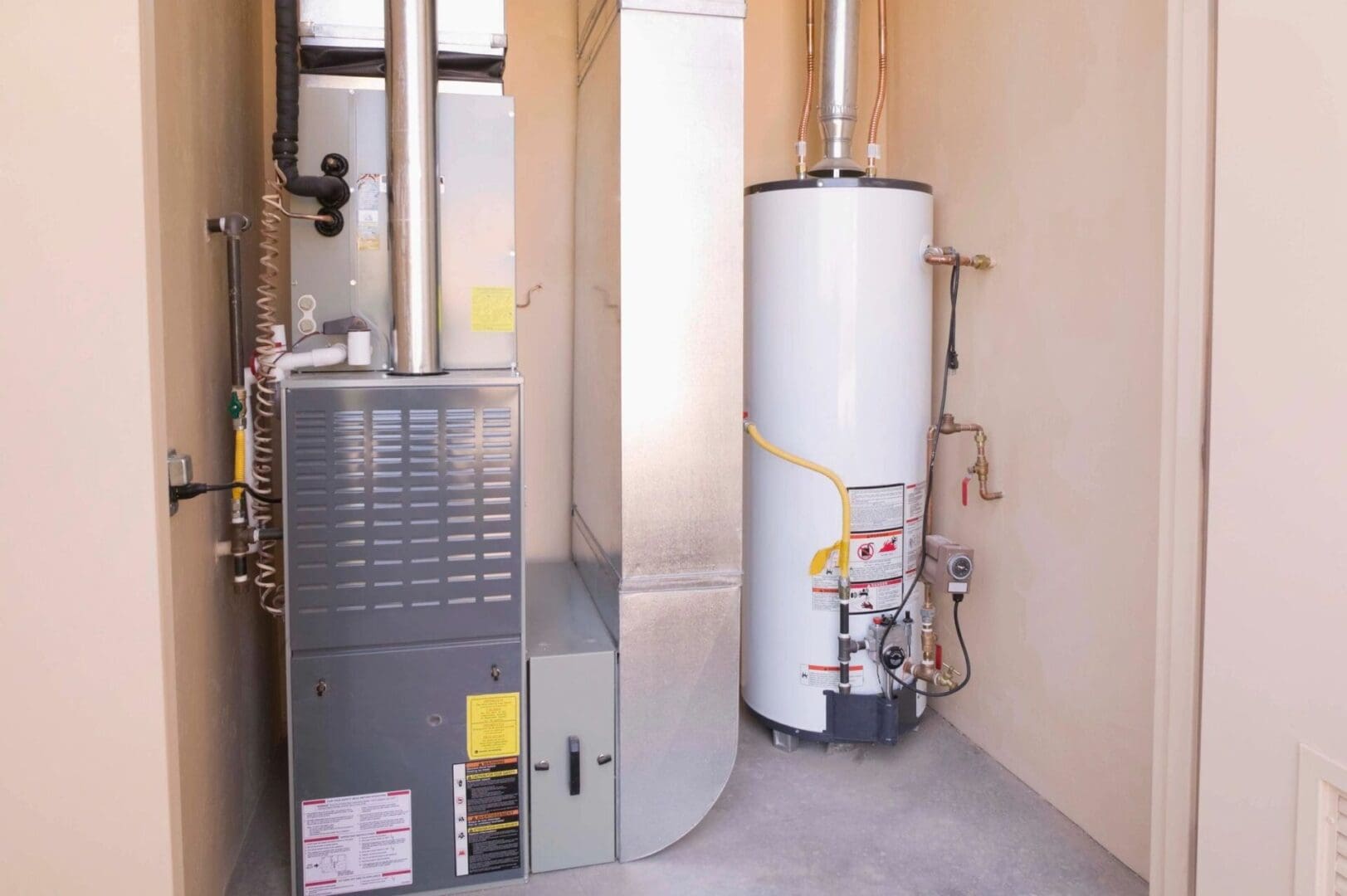 A gas furnace and water heater in a room.